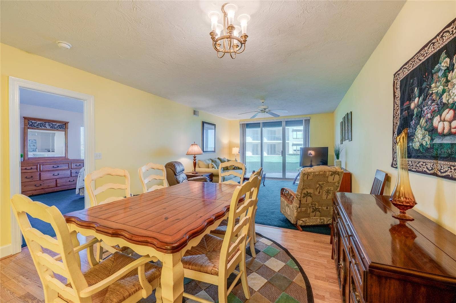 4575 S ATLANTIC AVENUE, #6101, Port Orange, FL 32127 A dedicated dining space with a stylish chandelier and ample room for a full-size table, seamlessly connected to the living area for easy entertaining.