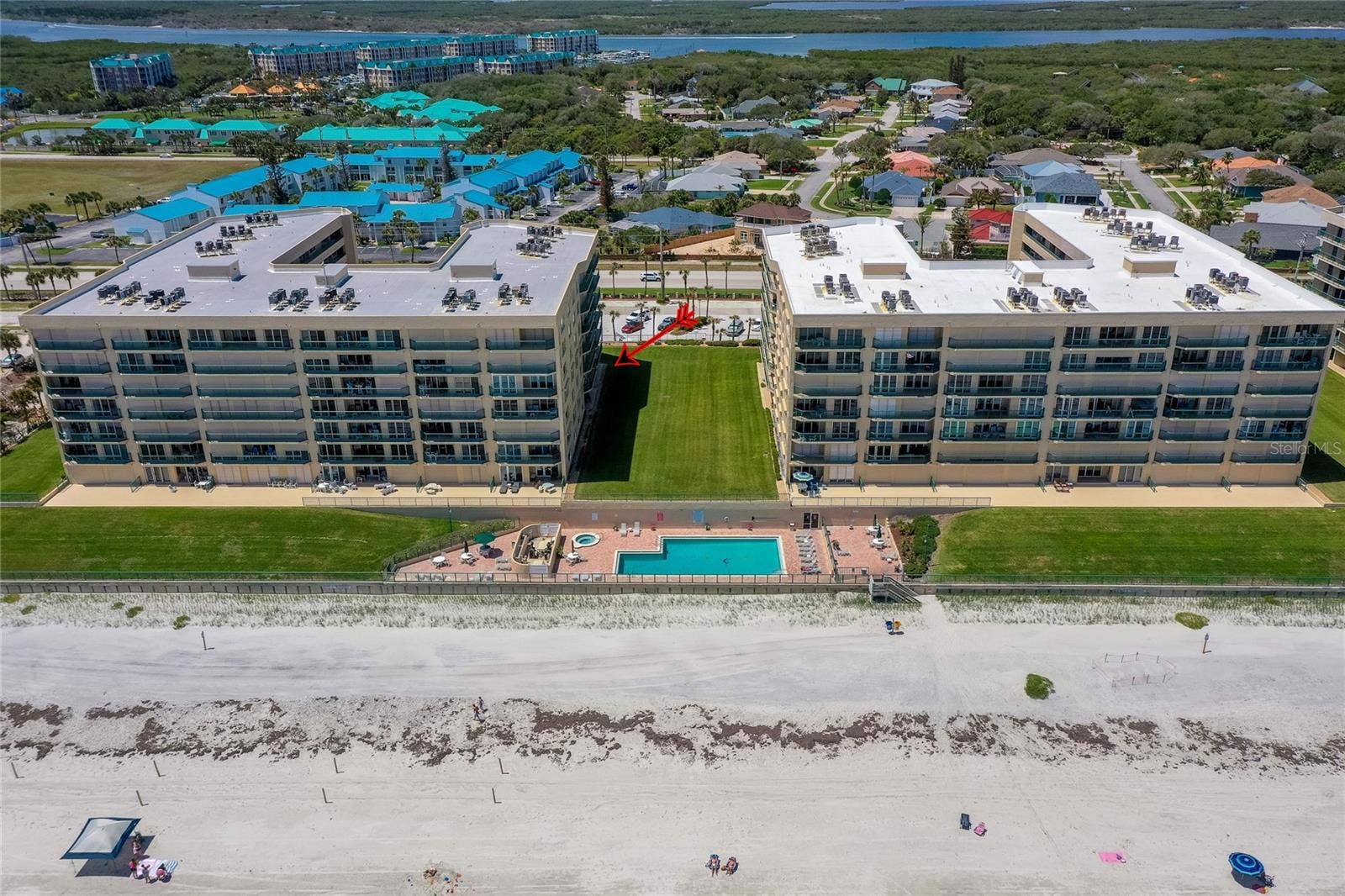4575 S ATLANTIC AVENUE, #6101, Port Orange, FL 32127 Resort-style pool and spa area situated just steps from the sand, offering a relaxing setting with ocean views.