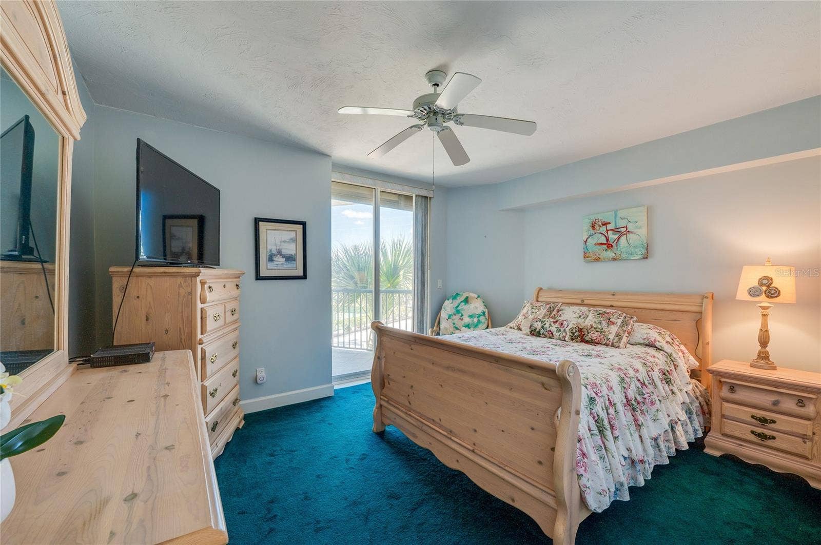 4575 S ATLANTIC AVENUE, #6101, Port Orange, FL 32127 This inviting bedroom includes a ceiling fan, and sliding glass doors that provide natural light and access to a private balcony.