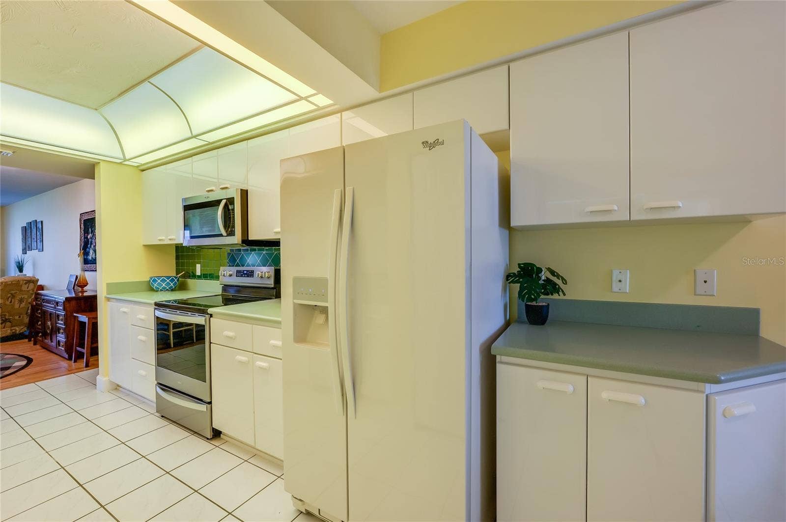 4575 S ATLANTIC AVENUE, #6101, Port Orange, FL 32127 The well-appointed kitchen includes abundant cabinetry, expansive countertops, and a full suite of appliances, offering both style and practicality for meal preparation.