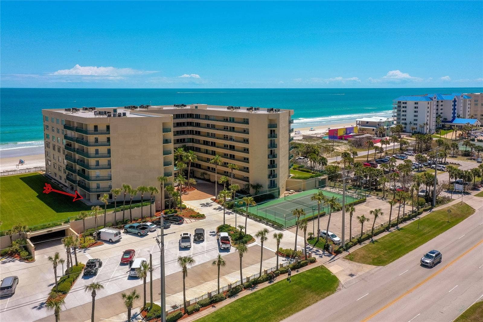 4575 S ATLANTIC AVENUE, #6101, Port Orange, FL 32127 Oblique aerial showcasing the propertys coastal positioning with easy access to both the ocean and nearby roadways.