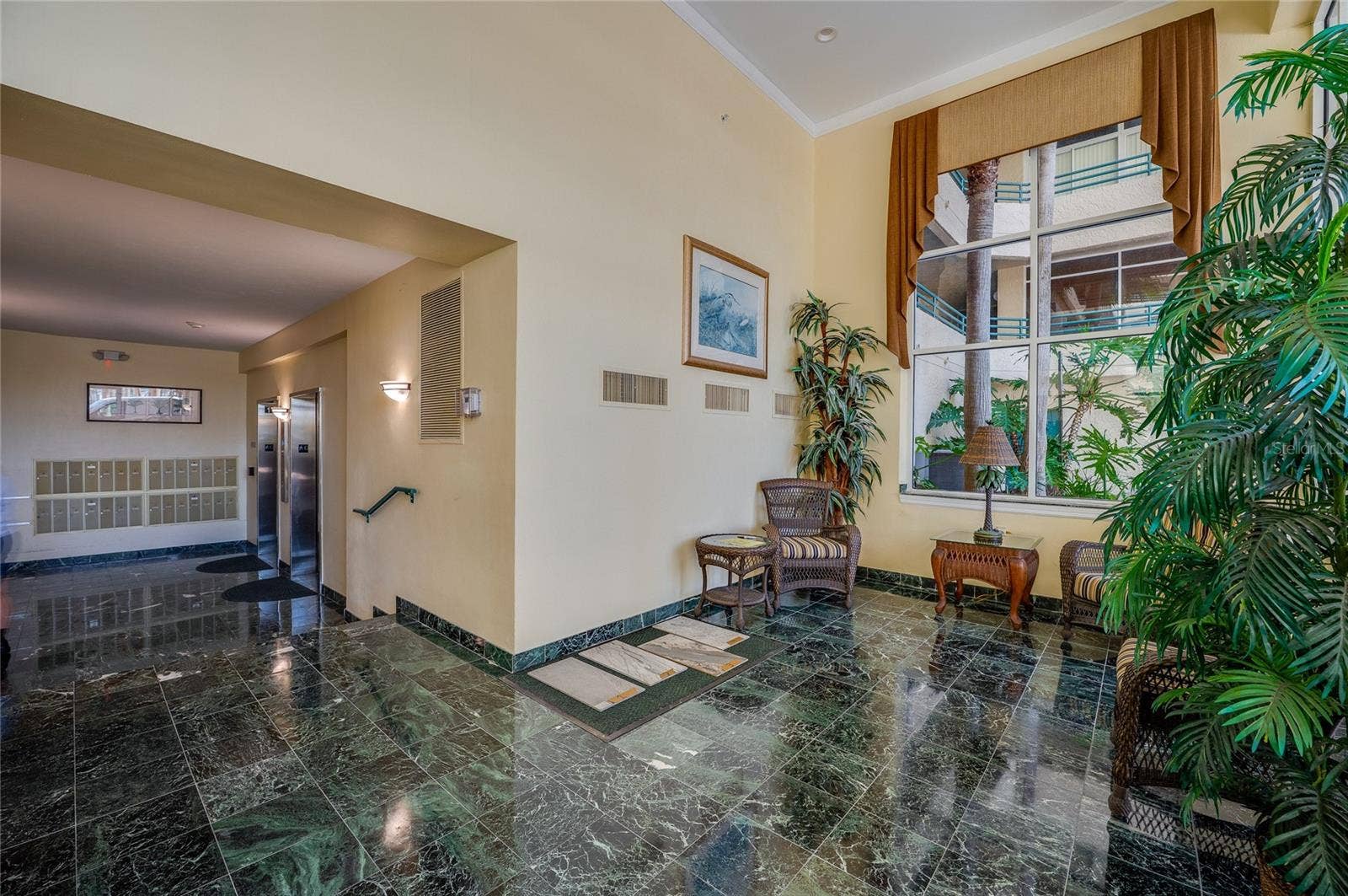 4575 S ATLANTIC AVENUE, #6101, Port Orange, FL 32127 A welcoming lobby with seating areas, polished flooring, and elevator access, offering a comfortable and secure entry for residents and guests.
