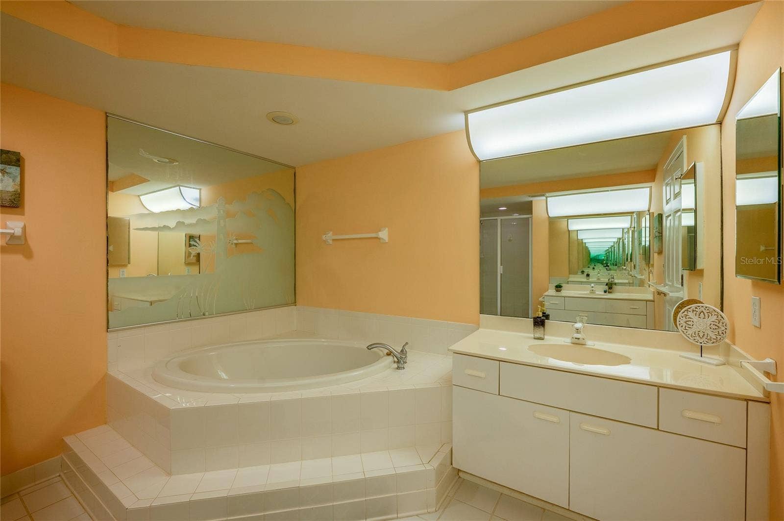 4575 S ATLANTIC AVENUE, #6101, Port Orange, FL 32127 A second view highlights the oversized vanity and soaking tub, offering both functionality and comfort.