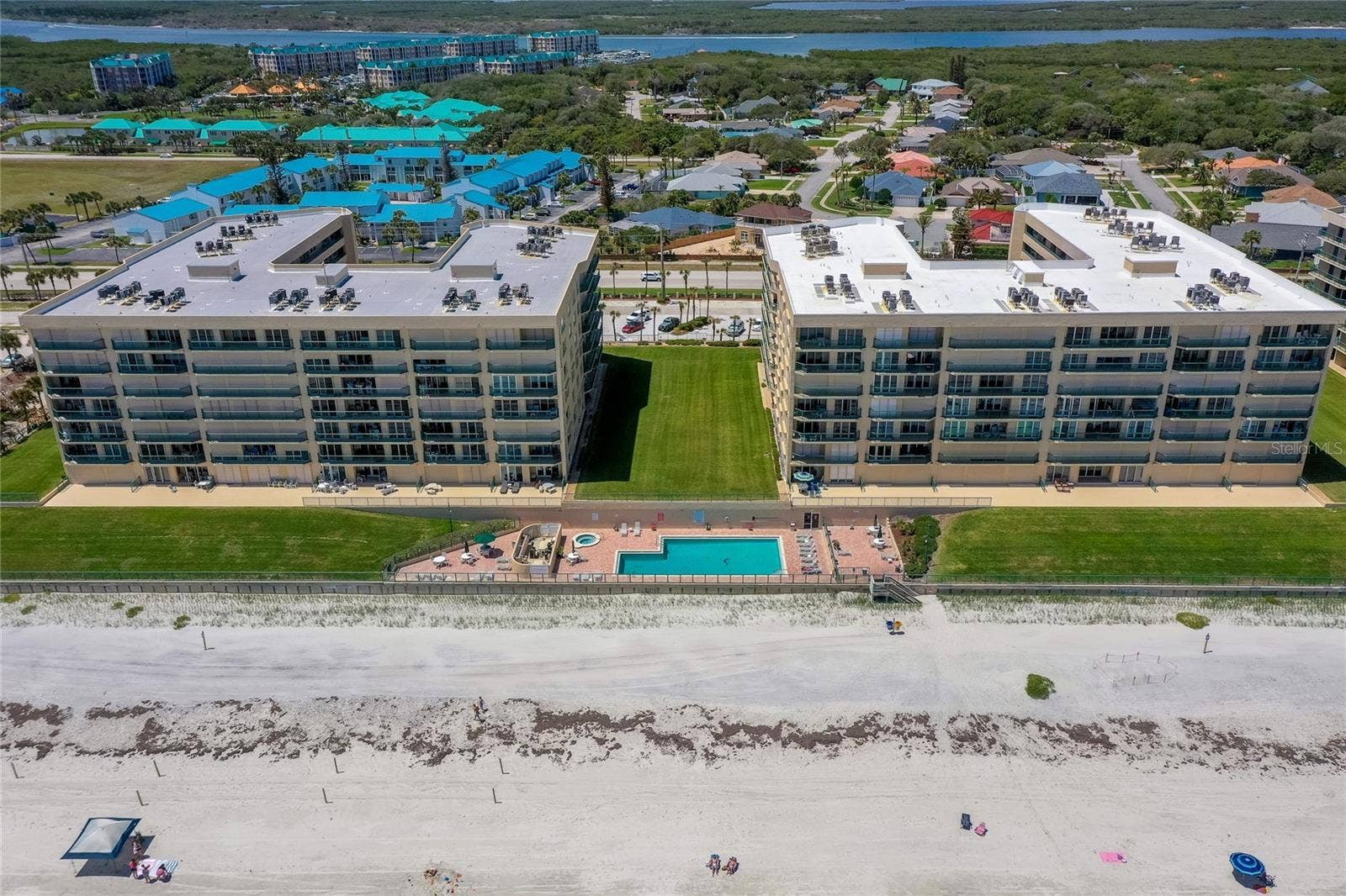 4575 S ATLANTIC AVENUE, #6101, Port Orange, FL 32127 Resort-style pool and spa area situated just steps from the sand, offering a relaxing setting with ocean views.