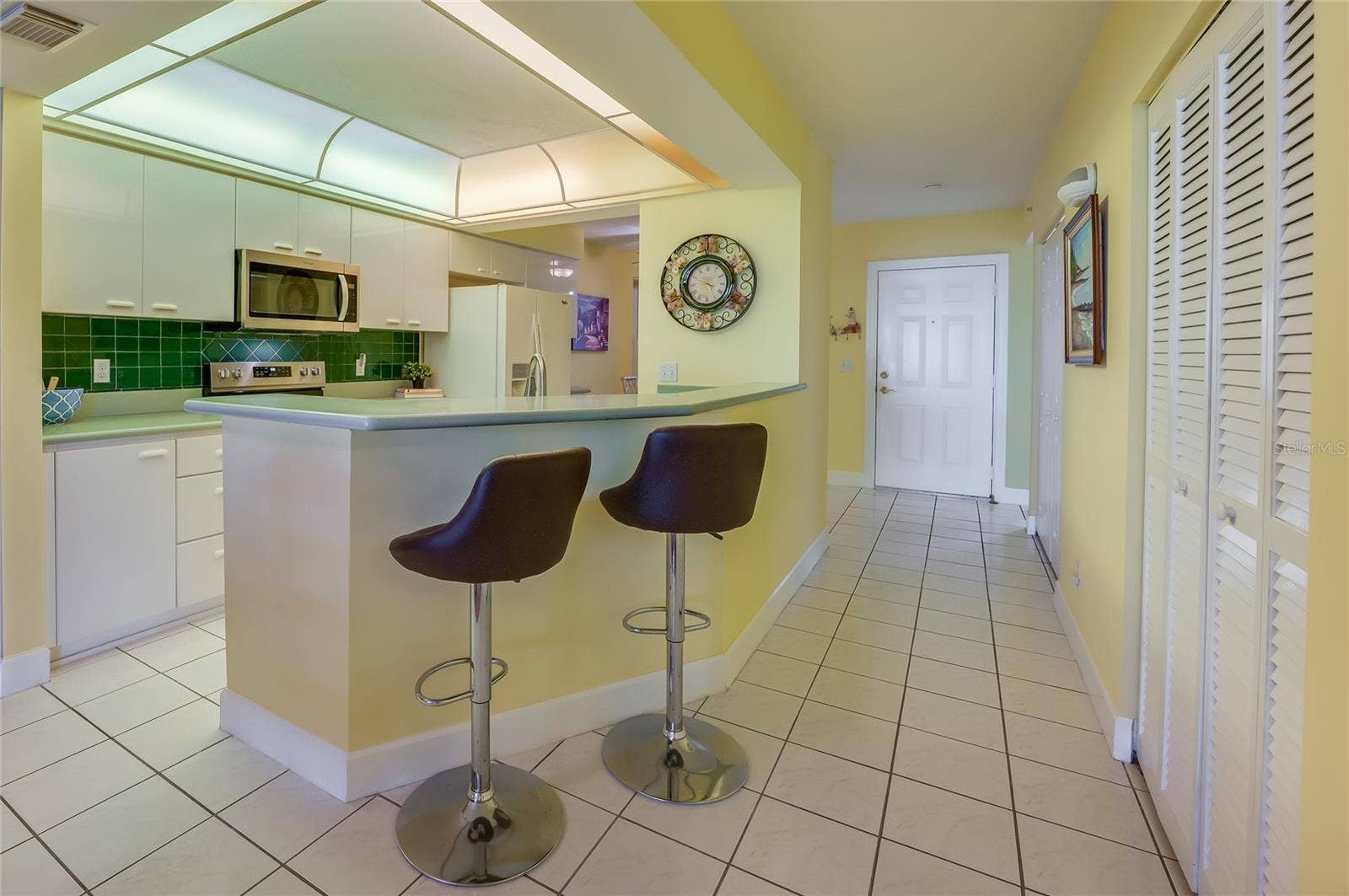 4575 S ATLANTIC AVENUE, #6101, Port Orange, FL 32127 A convenient breakfast bar with seating provides the perfect spot for casual meals or entertaining guests, while maintaining an open flow to the kitchen.