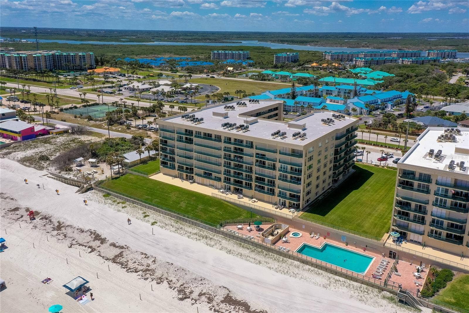 4575 S ATLANTIC AVENUE, #6101, Port Orange, FL 32127 Beachside perspective showing manicured green space, private patios, and direct beach access.