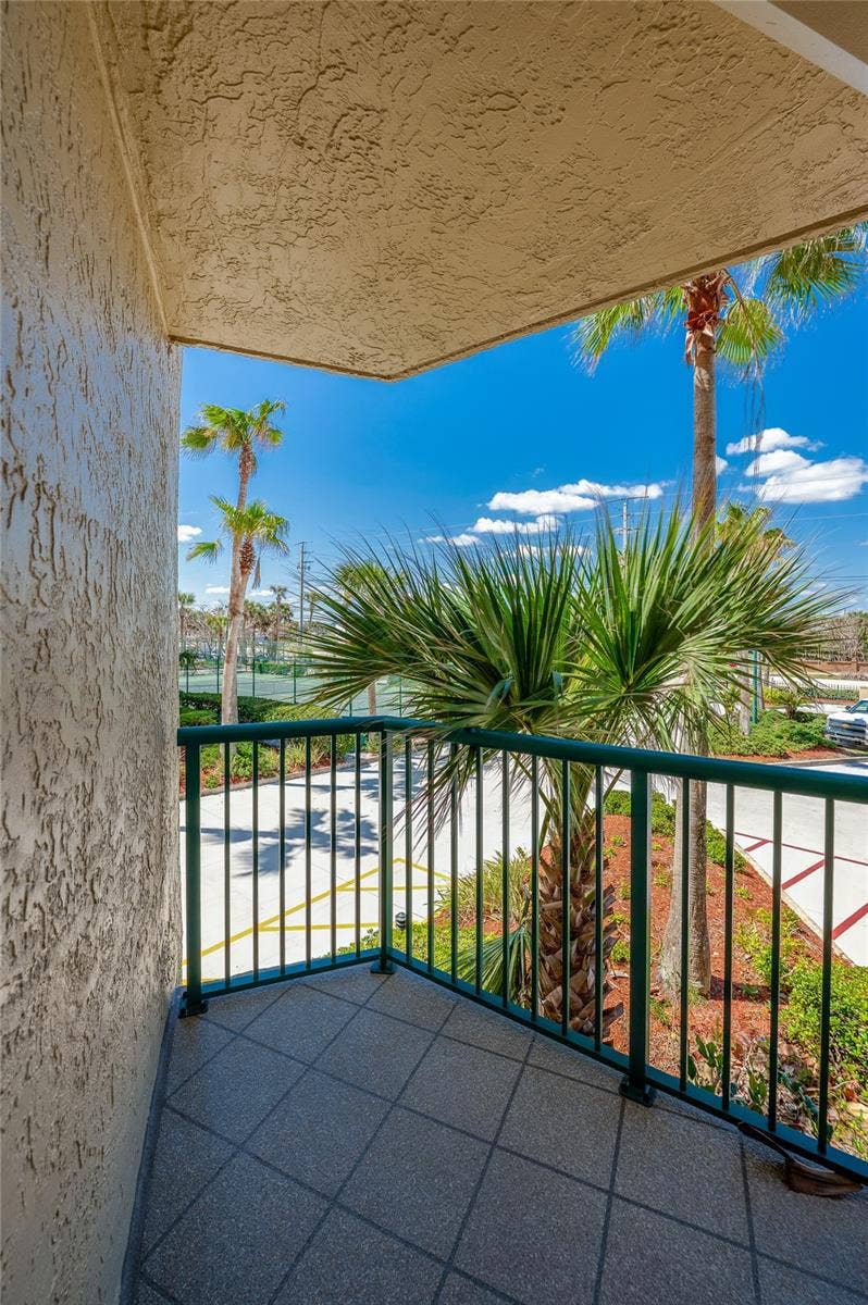 4575 S ATLANTIC AVENUE, #6101, Port Orange, FL 32127 Enjoy fresh coastal air from this private balcony overlooking lush landscaping and palm trees, creating a relaxing outdoor retreat.