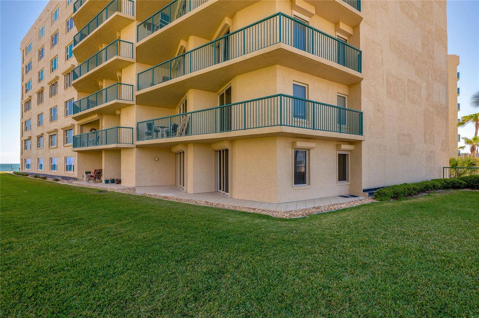 4575 S ATLANTIC AVENUE, #6101, Port Orange, FL 32127 Exterior view showcases the well-maintained building and direct unit access to outdoor spaces.