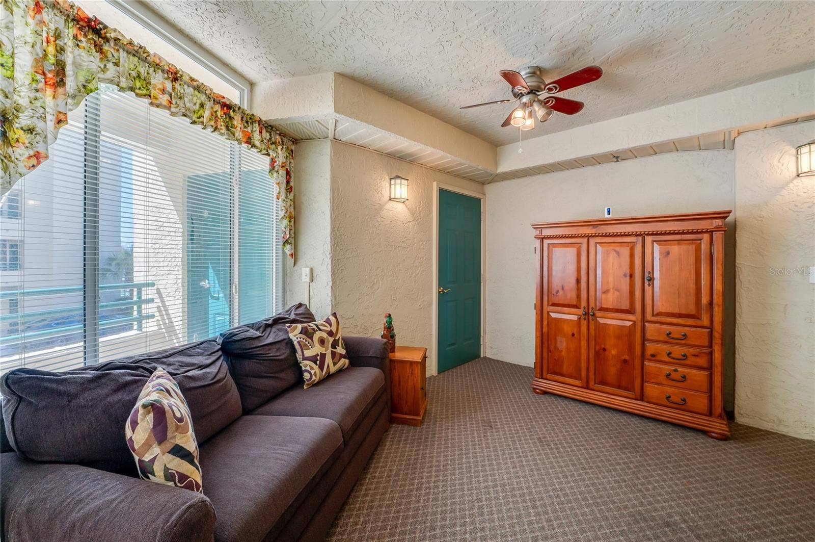 4575 S ATLANTIC AVENUE, #6101, Port Orange, FL 32127 This bright and inviting sunroom features expansive windows that fill the space with natural light. A ceiling fan and cozy seating area make it an ideal spot to relax and enjoy the view.