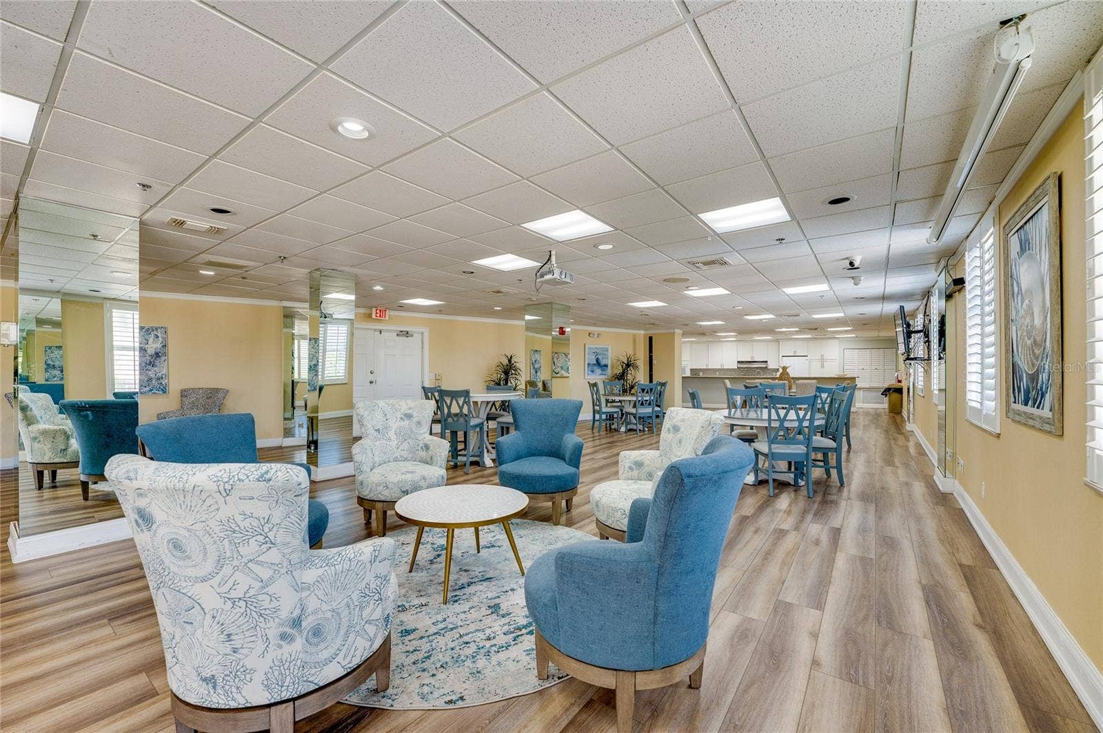 4575 S ATLANTIC AVENUE, #6101, Port Orange, FL 32127 Bright, open community room with dining tables, lounge seating, and large windows that bring in natural light.