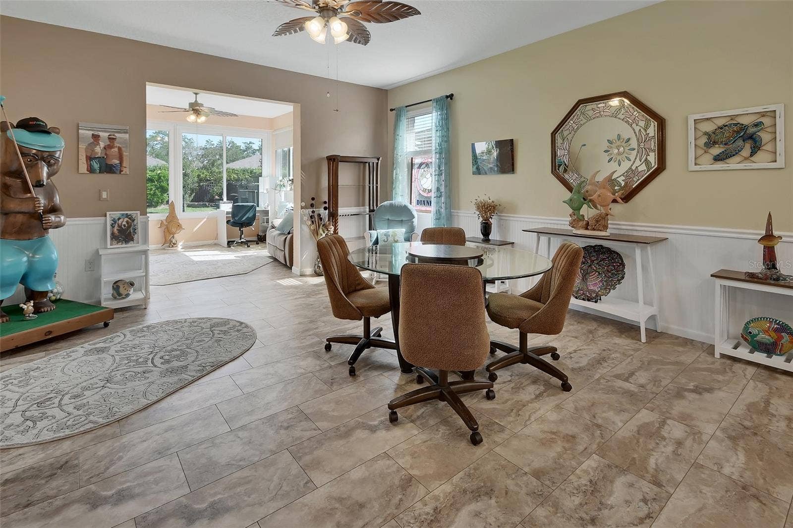 Spacious dining room for entertaining with wainscotting and chair rail.