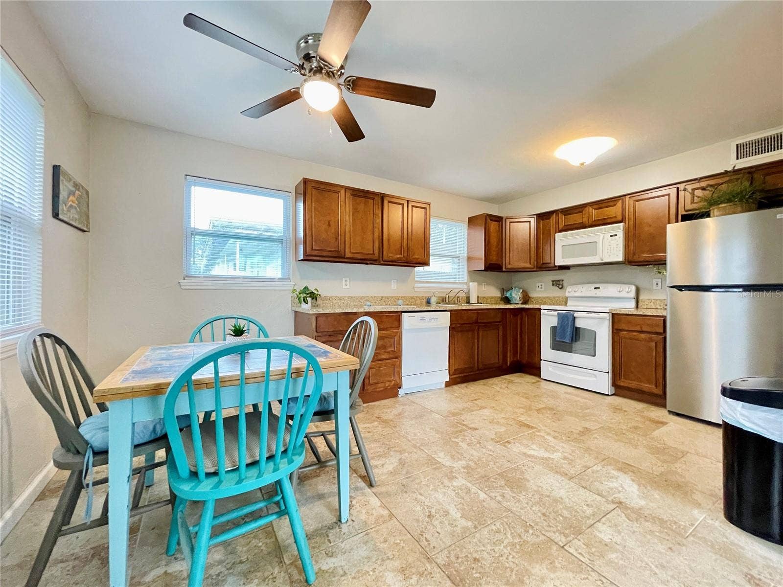 Natural light fills this inviting eat-in space, offering plenty of room for casual dining while keeping the kitchen close at hand.