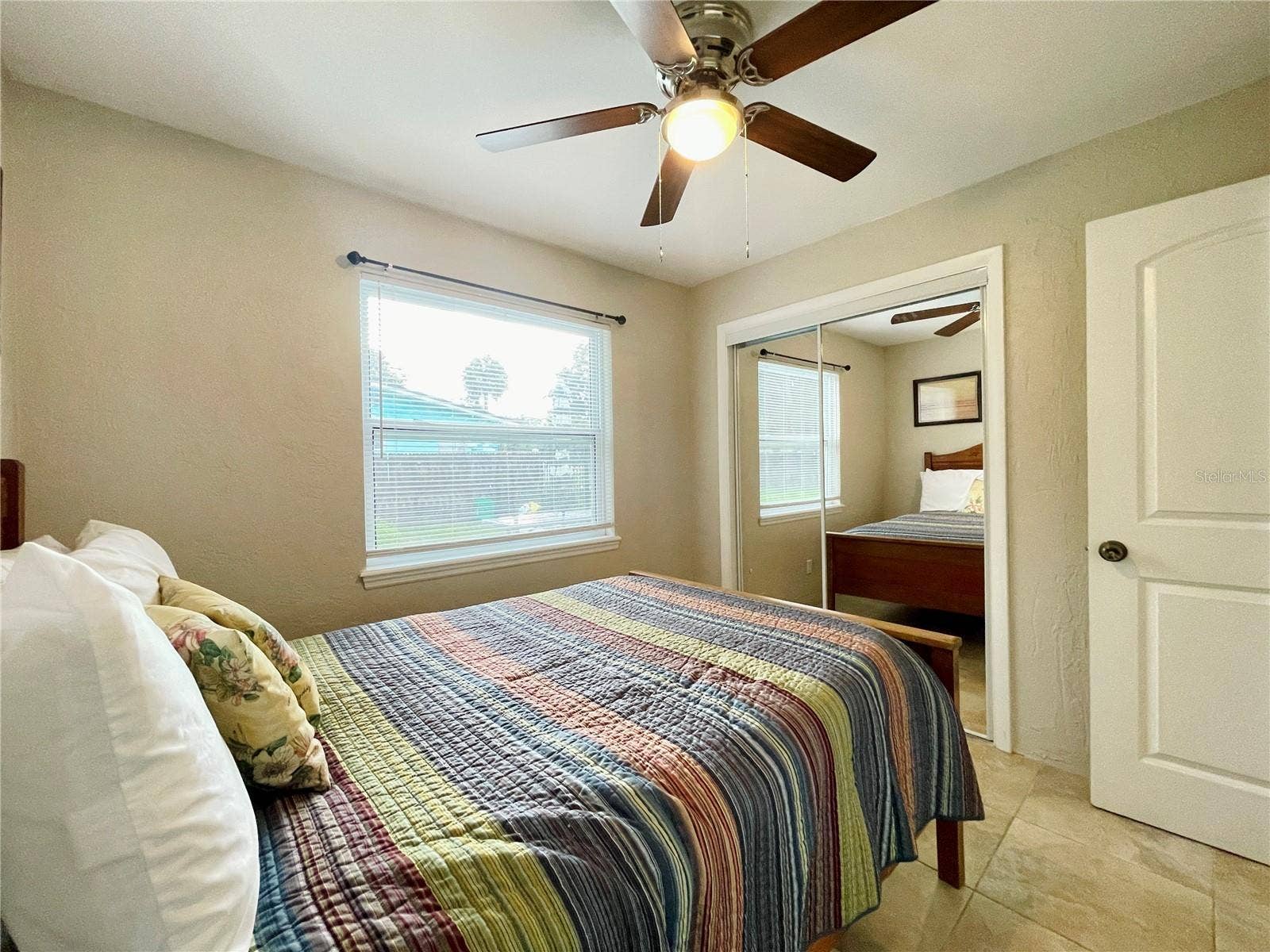 Another view of the bright bedroom with ample closet space.