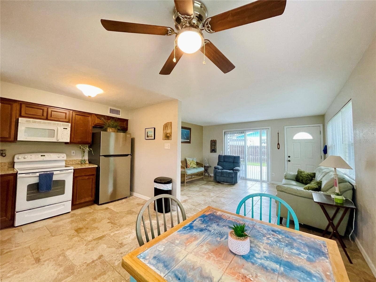 Multi-angle view of the functional kitchen and dining area, illustrating a fluid connection to the main living space for effortless entertaining.