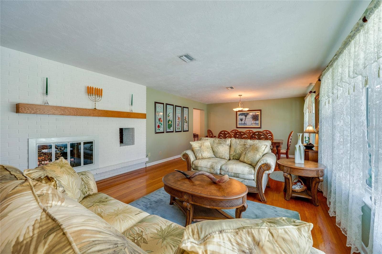 697 JOHN ANDERSON DRIVE, Ormond Beach, FL 32176 Living room with double-sided fireplace