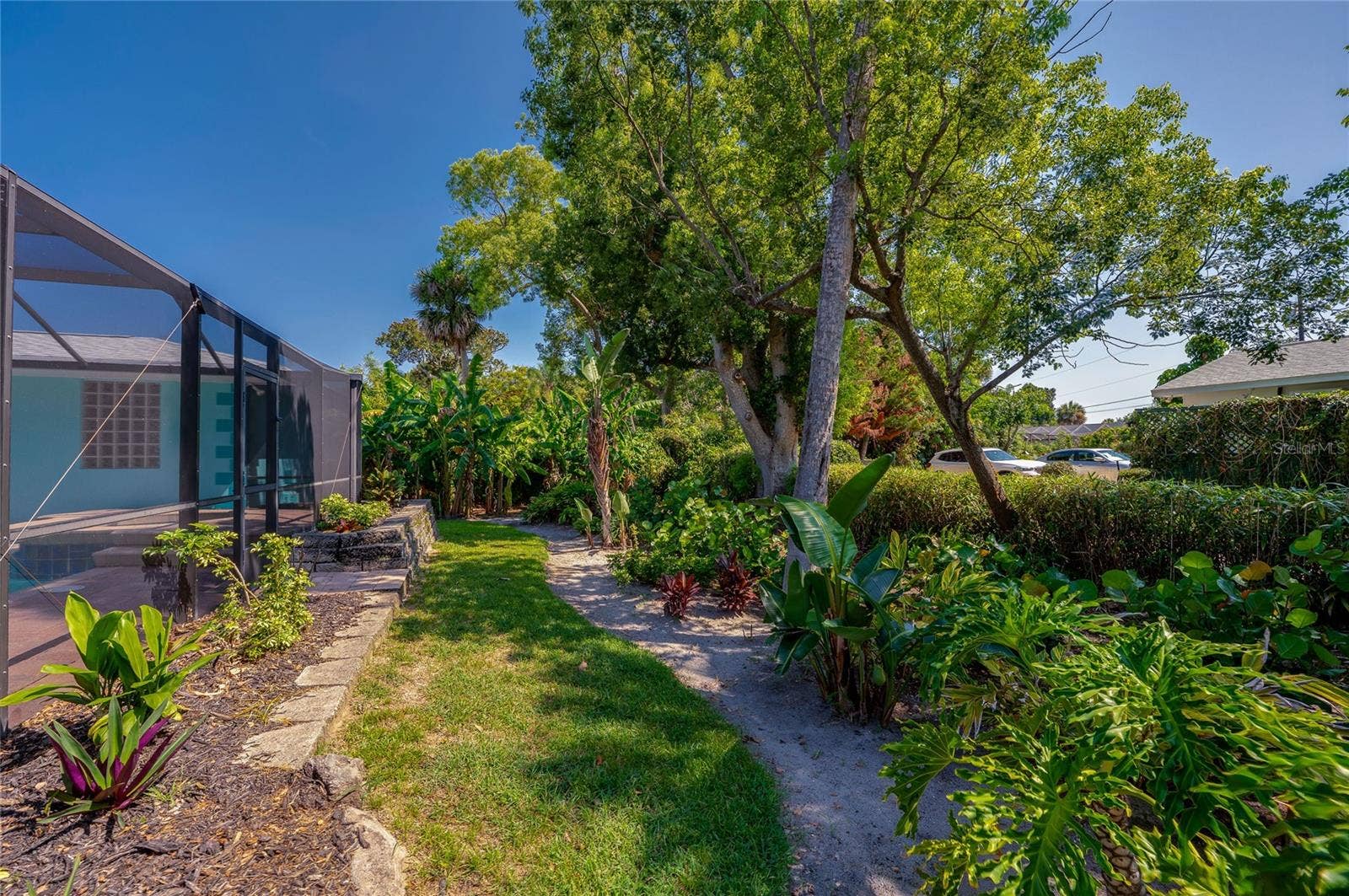 697 JOHN ANDERSON DRIVE, Ormond Beach, FL 32176 Lush tropical landscaping behind pool