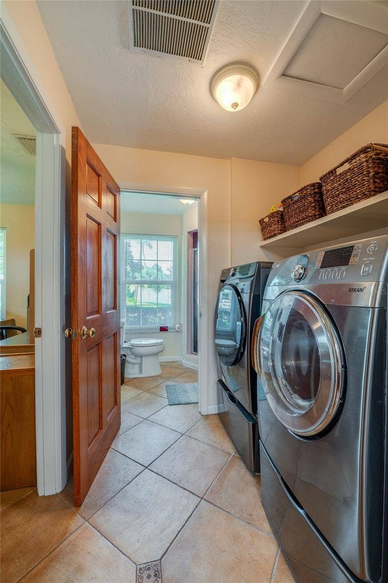 697 JOHN ANDERSON DRIVE, Ormond Beach, FL 32176 Laundry with office on left and 3rd bathroom