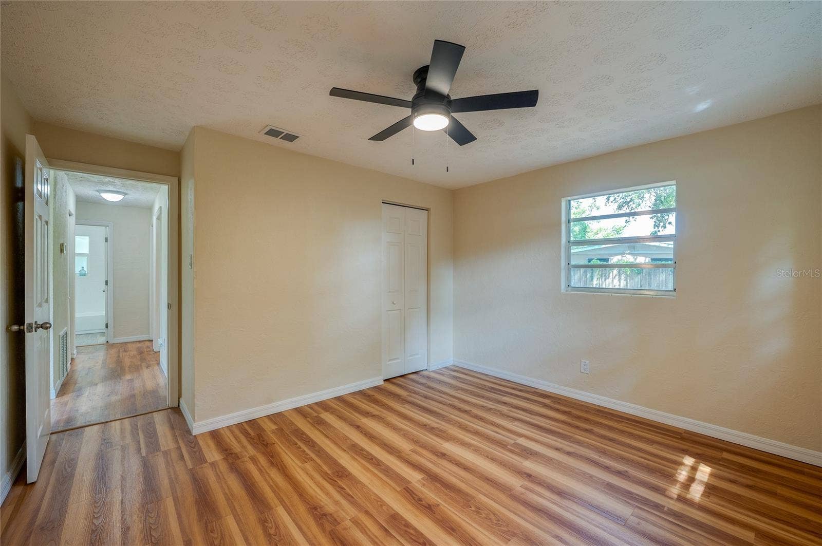 1220 LEON LANE, Daytona Beach, FL 32117 Alternate view of the bedroom showcasing its generous layout and convenient closet storage.
