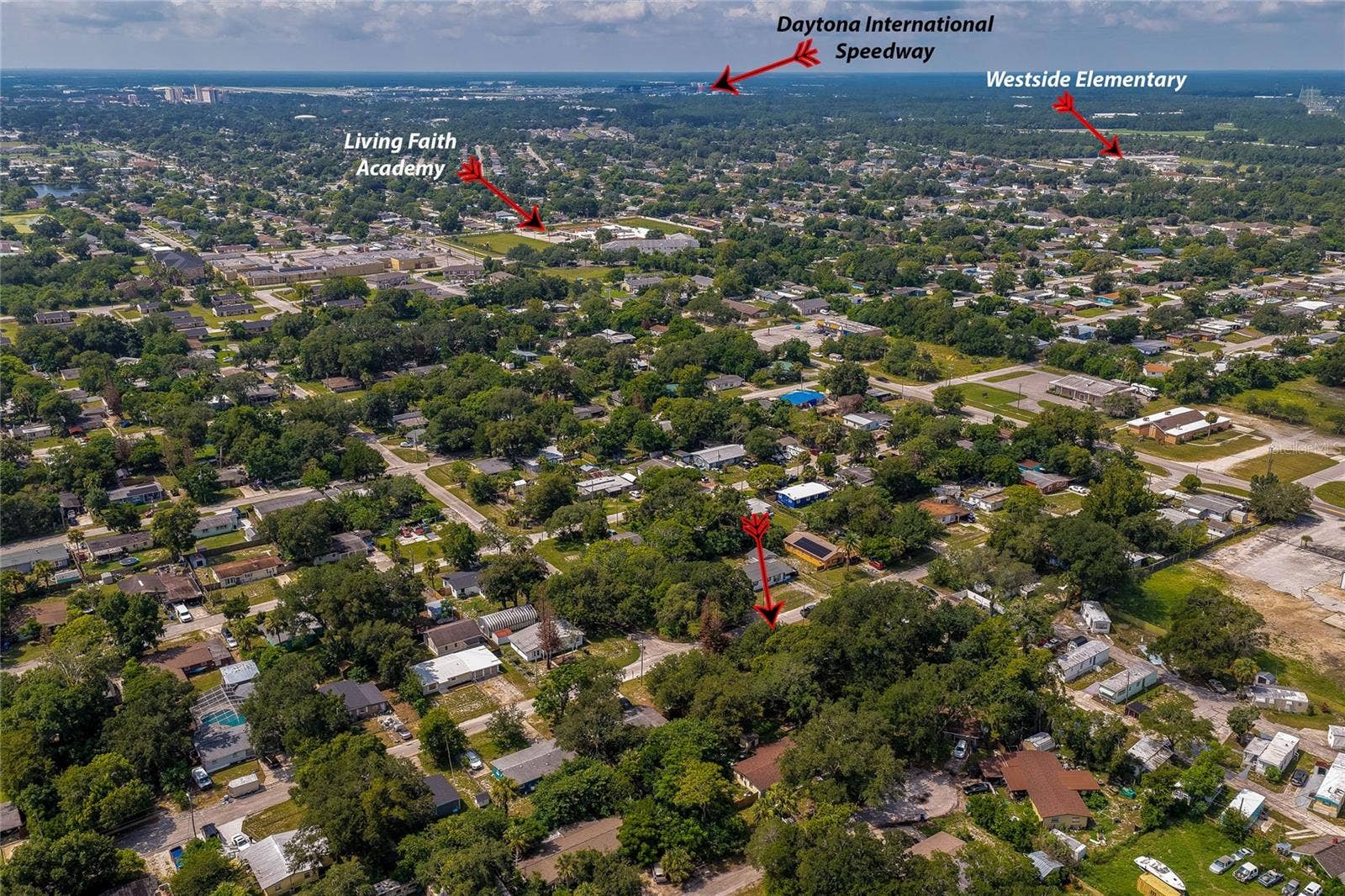 1220 LEON LANE, Daytona Beach, FL 32117 Elevated aerial view highlighting the home's convenient location near Daytona International Speedway, and other nearby destinations.
