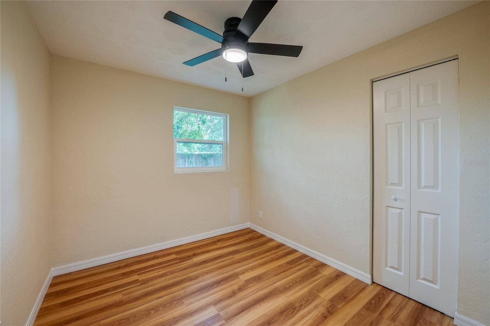 1220 LEON LANE, Daytona Beach, FL 32117 Comfortable secondary bedroom featuring a ceiling fan, closet, and window that provides natural light.