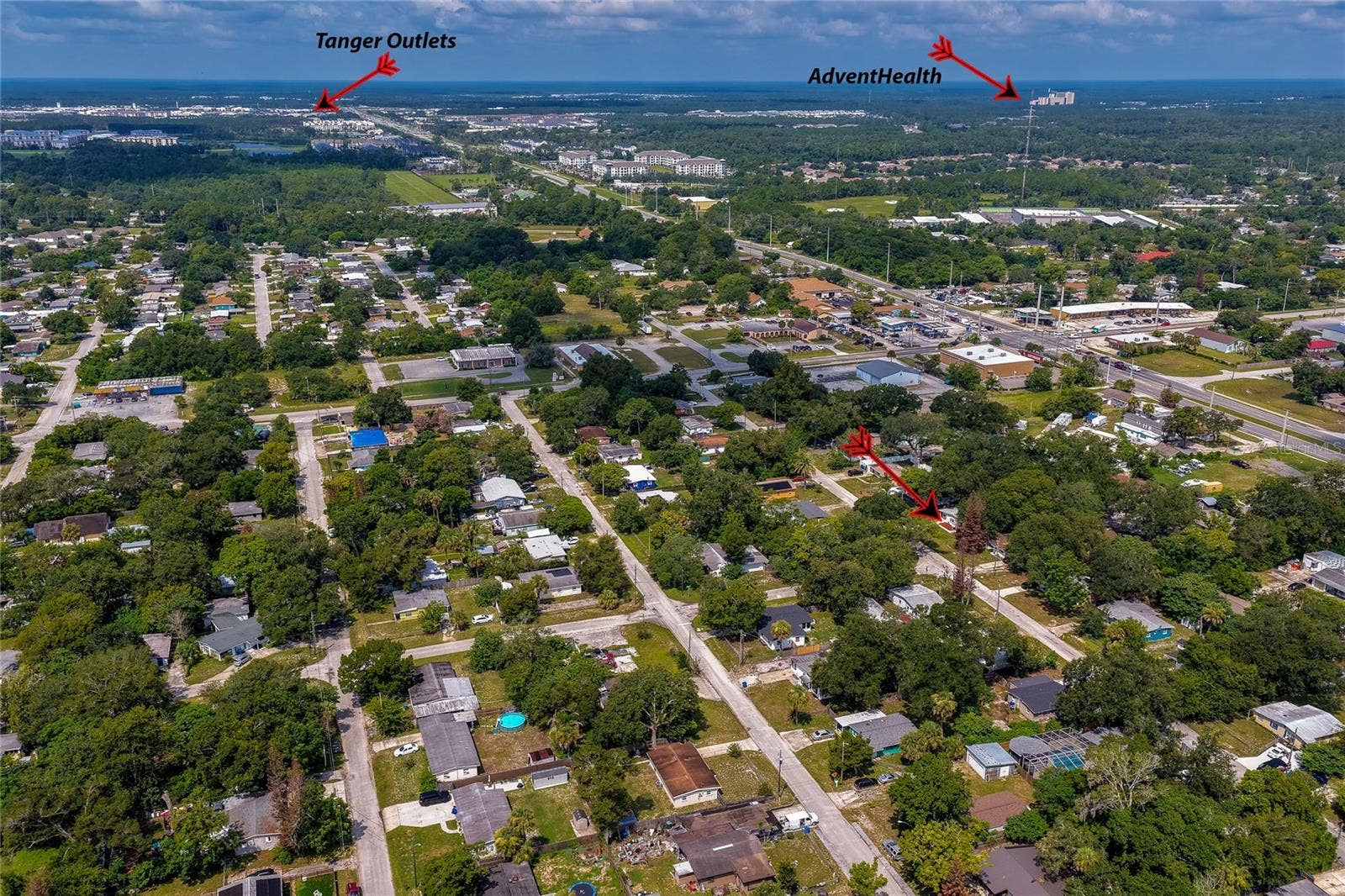 1220 LEON LANE, Daytona Beach, FL 32117 Aerial perspective showcasing proximity to AdventHealth, Tanger Outlets, and major shopping, dining, and commuter routes.