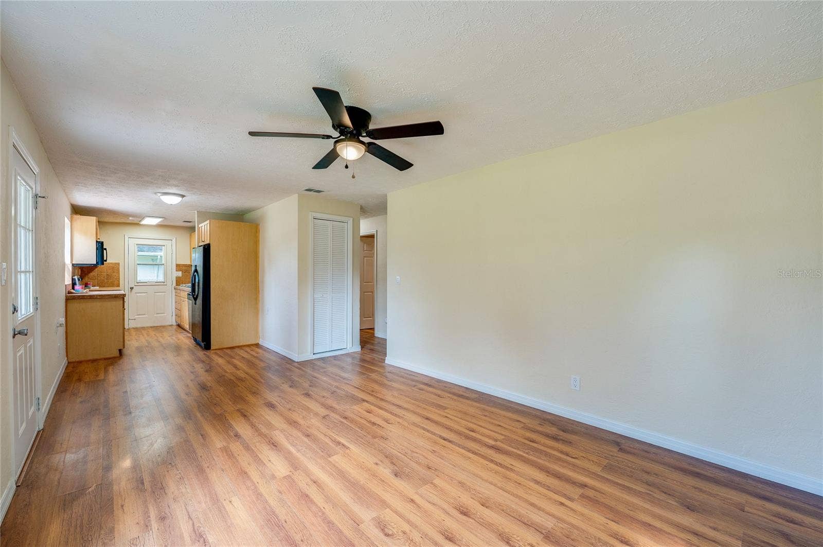 1220 LEON LANE, Daytona Beach, FL 32117 Another view of the open living space showcasing its versatile layout and easy connection to the kitchen.