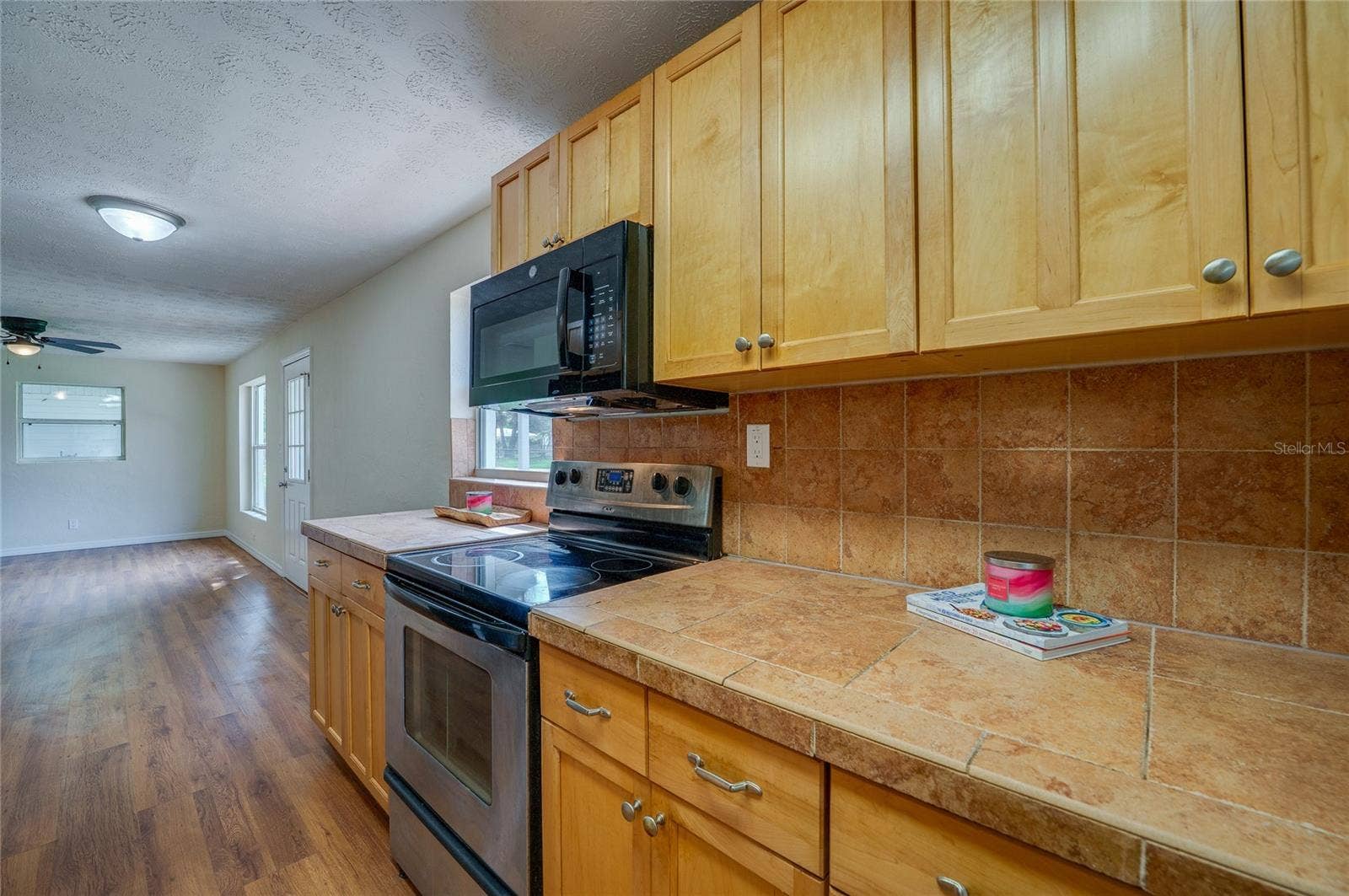 1220 LEON LANE, Daytona Beach, FL 32117 View highlighting the kitchen's practical design and open sightlines into the main living area.