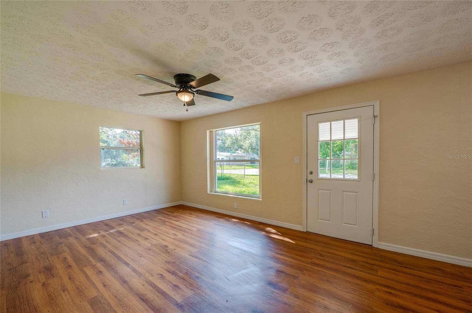 1220 LEON LANE, Daytona Beach, FL 32117 Sunlit living space with oversized windows and a comfortable layout that's ideal for everyday living and entertaining.
