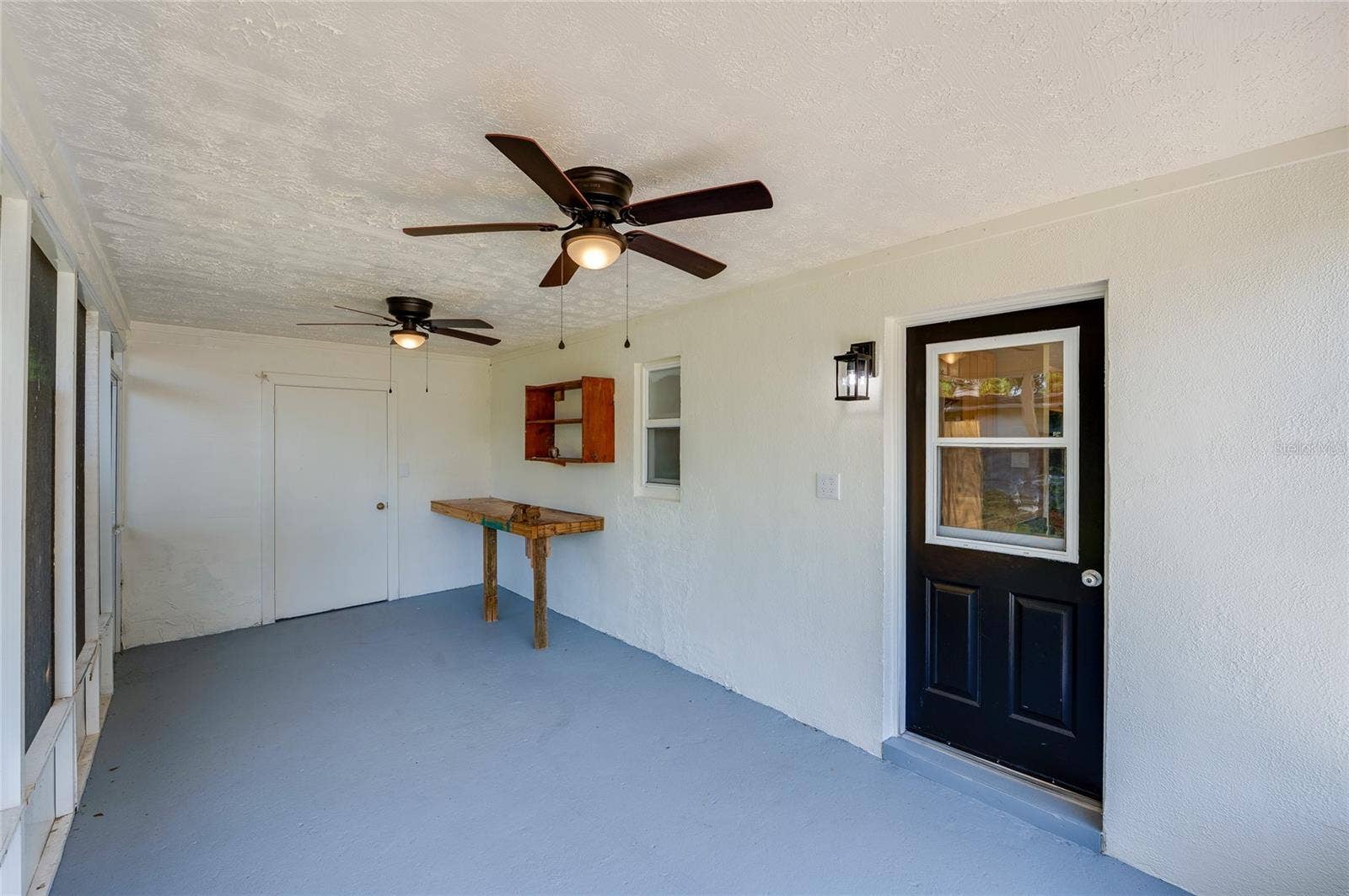 1220 LEON LANE, Daytona Beach, FL 32117 Another view of the expansive screened porch showcasing ample space for outdoor seating and easy access to the home and backyard.