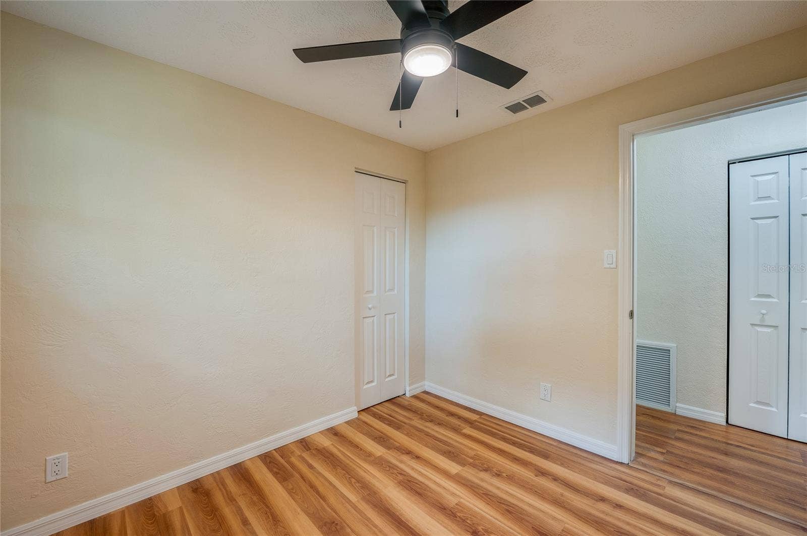 1220 LEON LANE, Daytona Beach, FL 32117 Alternate view highlighting the bedroom's efficient layout, neutral finishes, and convenient closet storage.