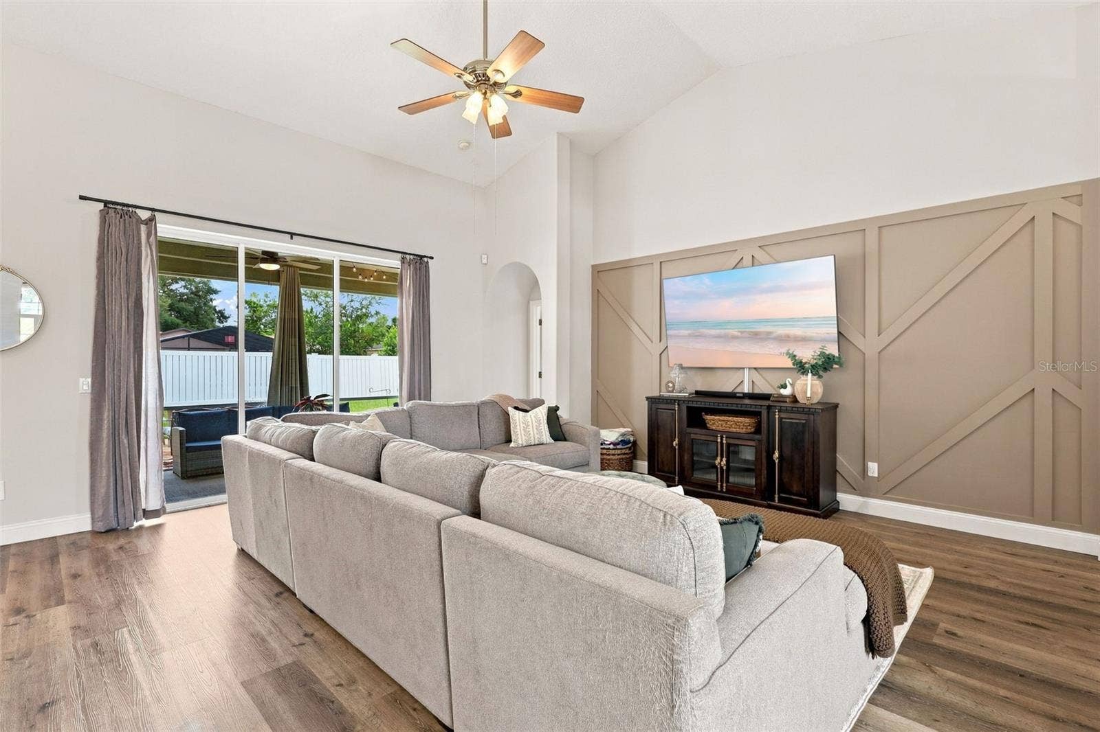 Main living area with vaulted ceiling and porch access