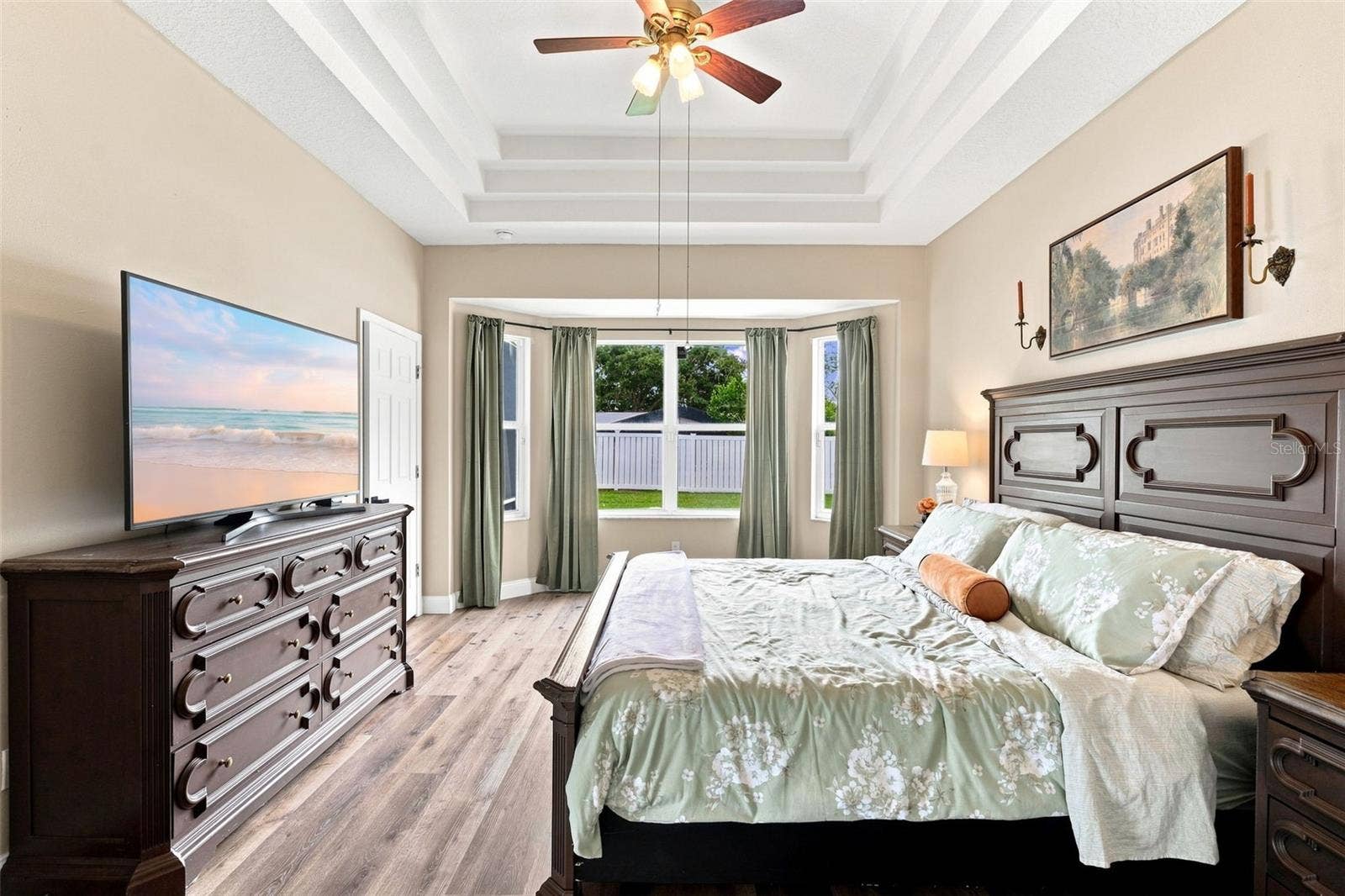 Primary bedroom with bay window view.