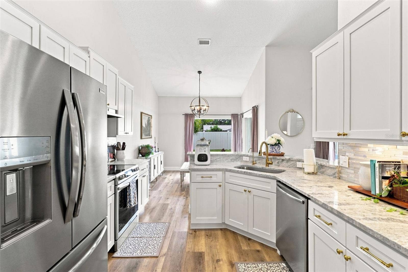 Updated kitchen with tons of soft-close cabinetry, stainless steel appliances and custom backsplash.