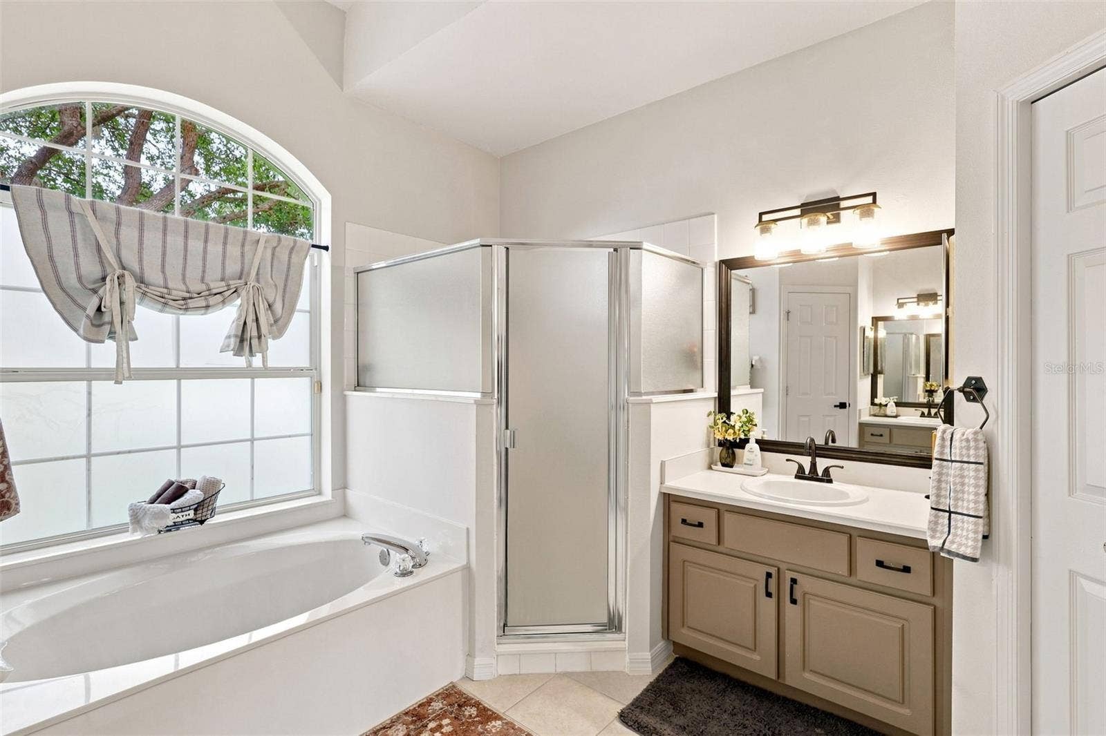 Primary ensuite bathroom with garden soaking tub and large walk-in shower.