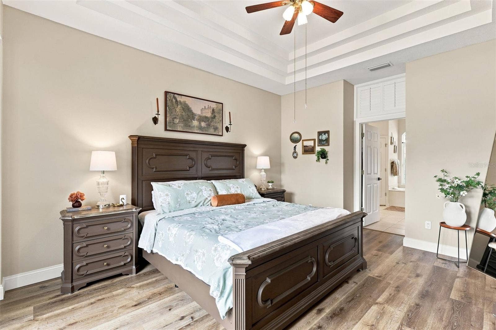 Primary bedroom suite towards walk-in closets and ensuite bath.