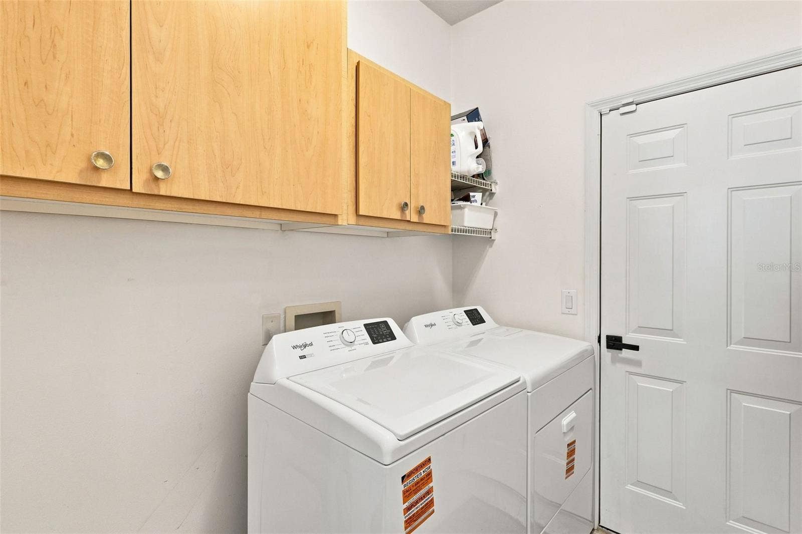 Indoor laundry room towards garage.