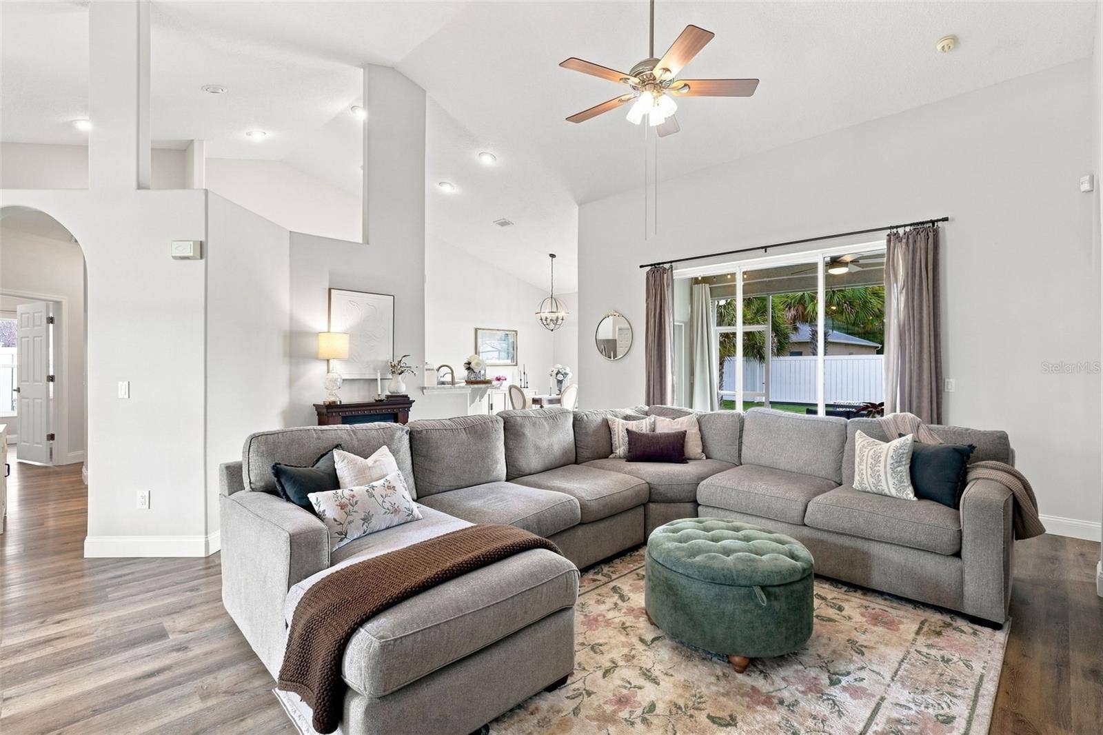 Main living area towards triple pocket sliders and the screened lanai.
