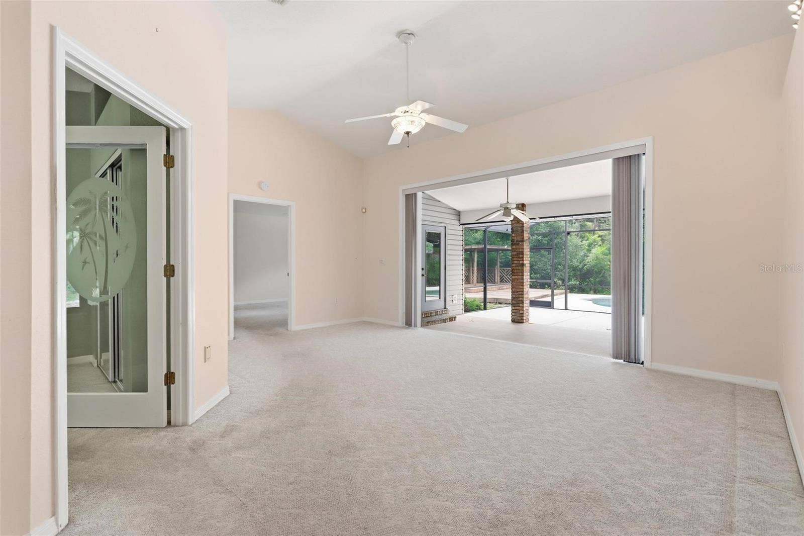 Sliding fully opened onto back patio.  Office/bedroom #3 on right, primary straight ahead.