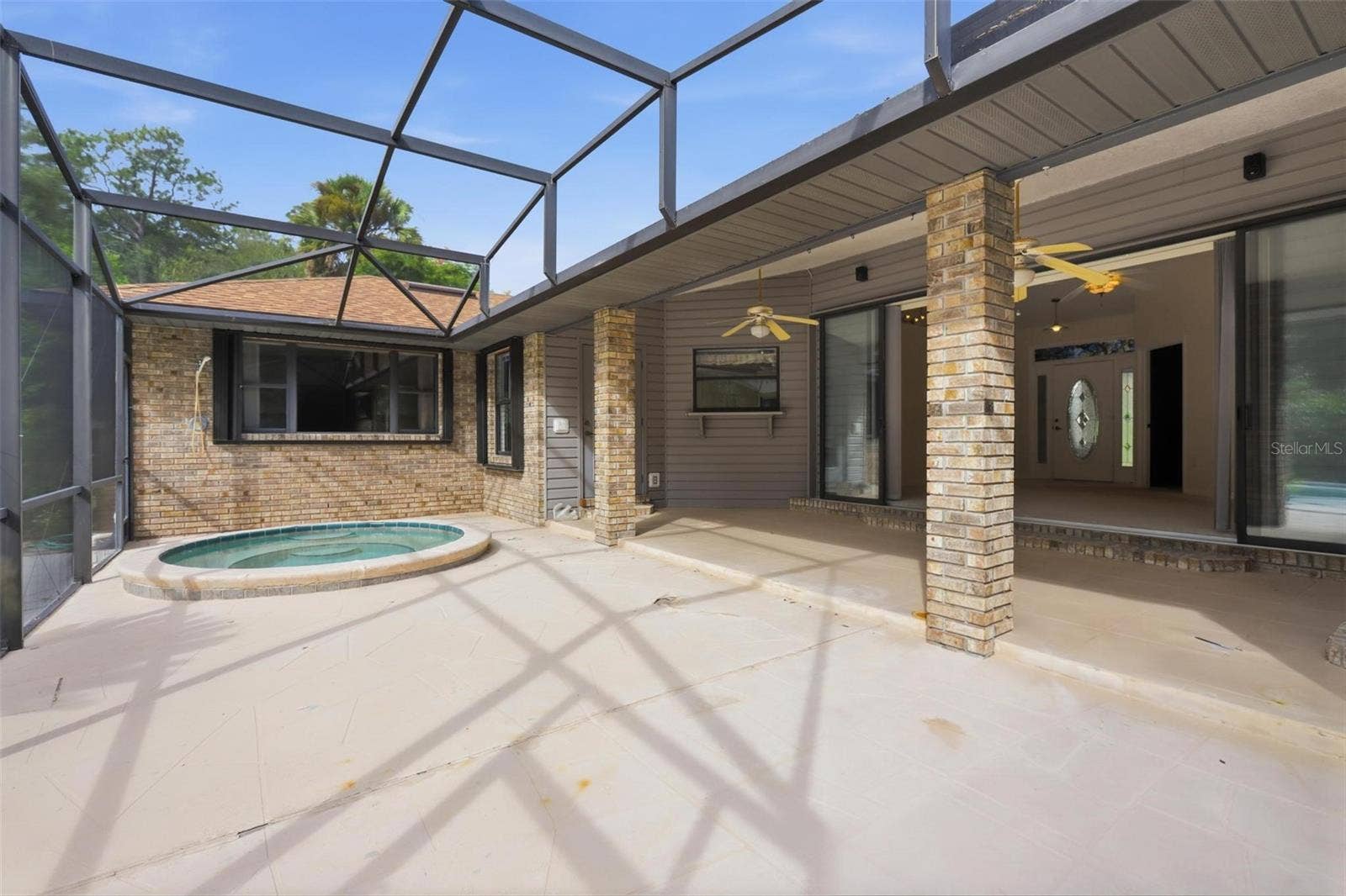 Screened patio with sunken spa.