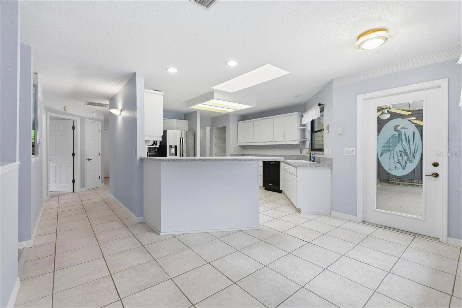 Kitchen on right.  Door to patio.  Bedroom #2 straight ahead.