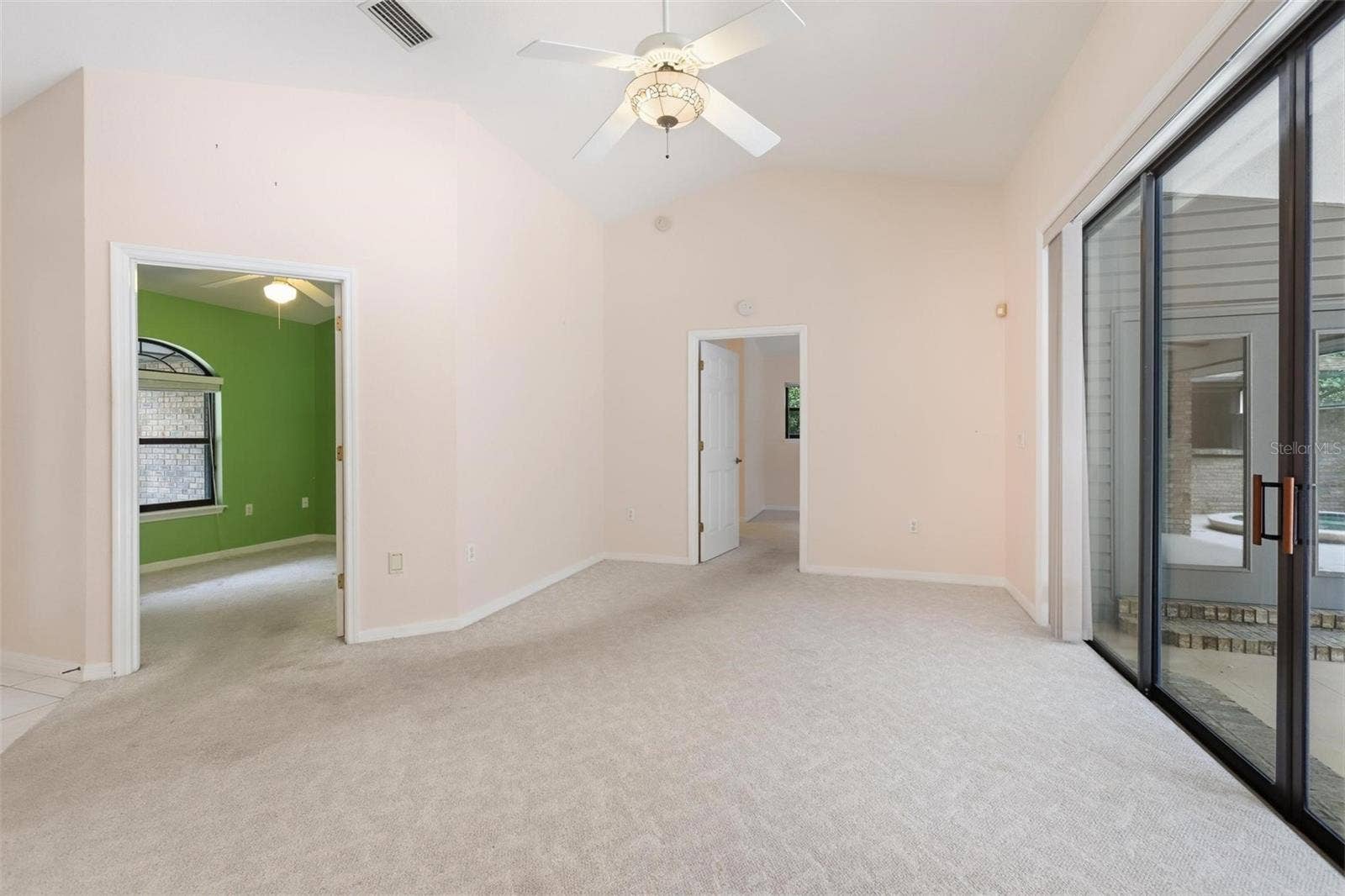 Living room looking into bedroom #3/office and primary bedroom.  Sliders on right completely "pancake" into wall.