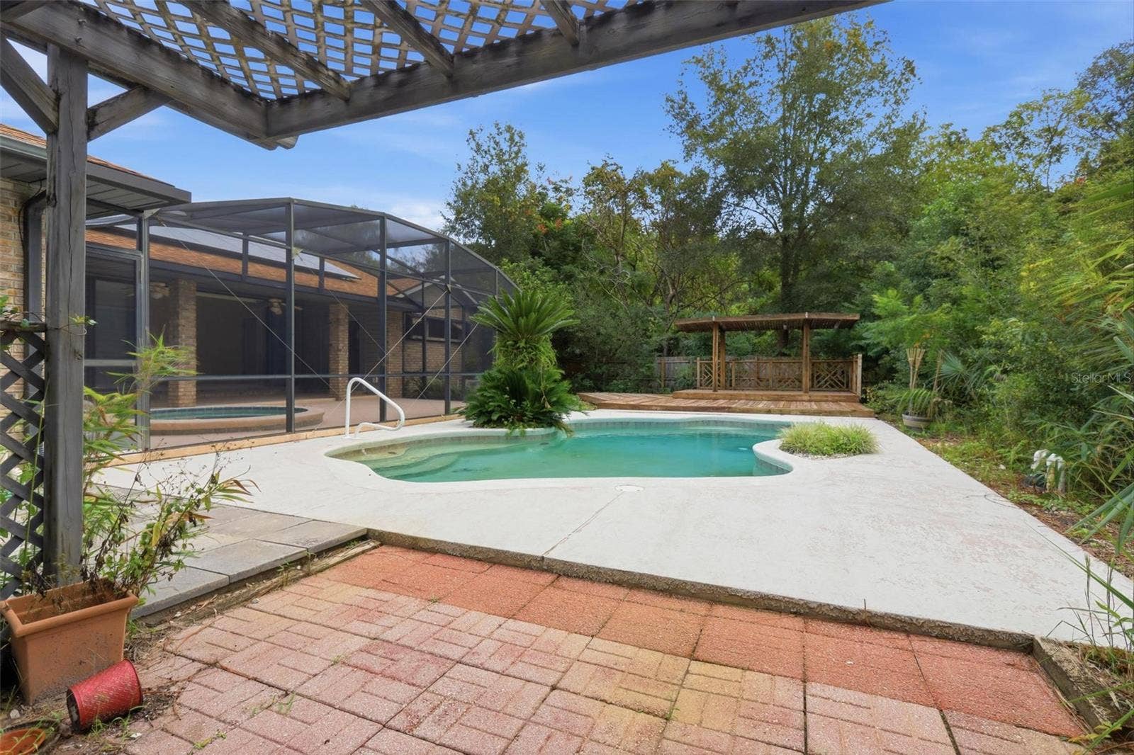 From BBQ/potting shed looking east to pool and covered deck.
