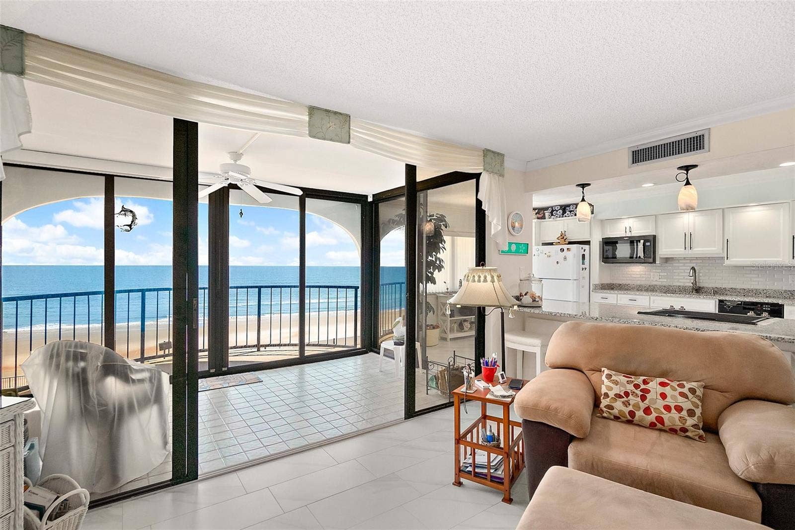 Large living room with covered lanai and balcony