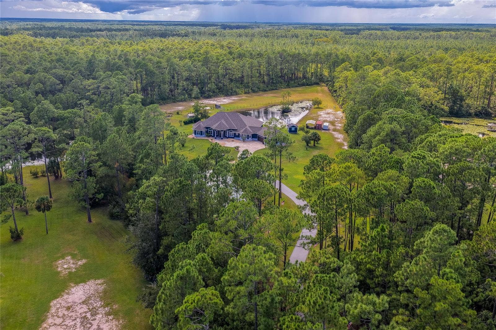 25 REMINGTON ROAD, Ormond Beach, FL 32174 Expansive aerial view showcasing a private home. The setting offers absolute privacy amidst nature.