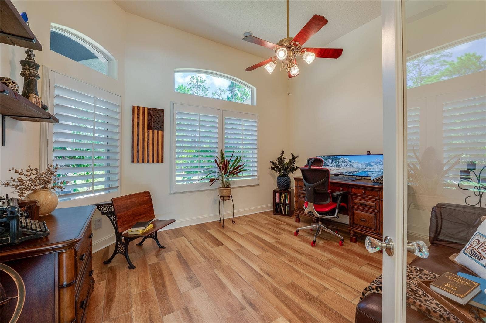 25 REMINGTON ROAD, Ormond Beach, FL 32174 Bright private office space outfitted with tile flooring, ceiling fan, and large windows with plantation shutters for natural light.