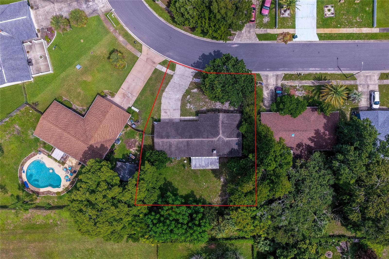 146 WESTWOOD DRIVE, Daytona Beach, FL 32119 Direct overhead aerial view displaying the property boundaries outlined in red, including the house roof, driveway, screened porch, and yard.
