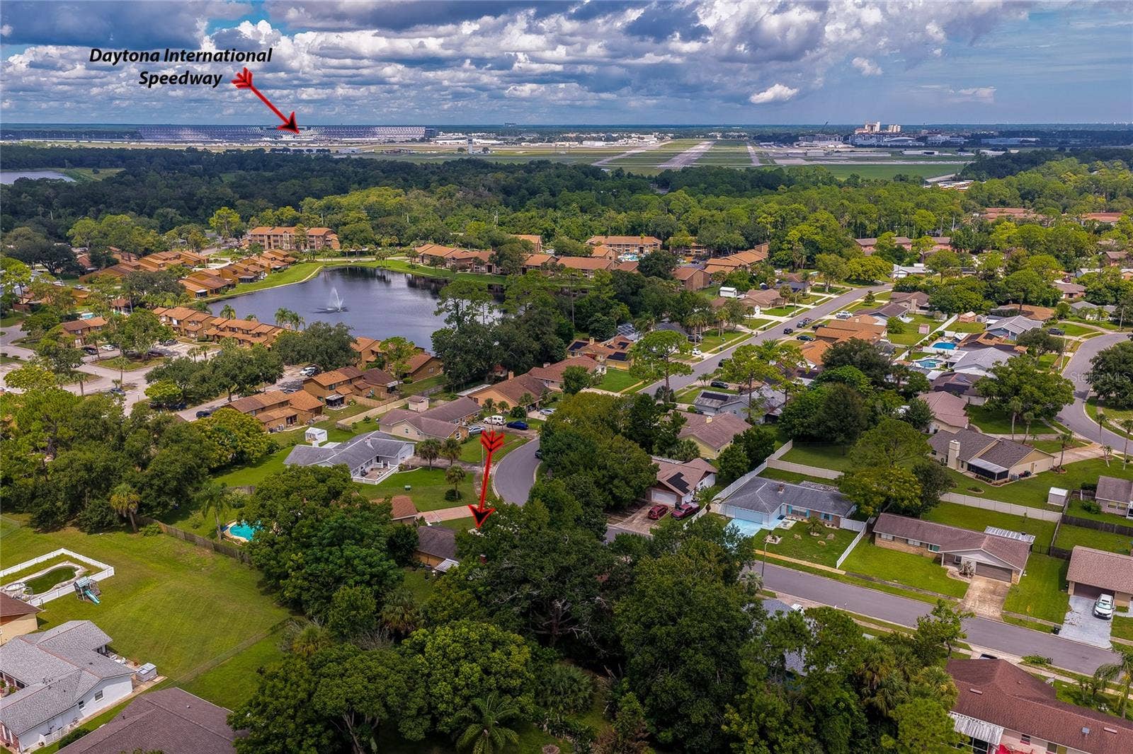 146 WESTWOOD DRIVE, Daytona Beach, FL 32119 Elevated aerial view pointing out the property location relative to nearby landmarks, including Daytona International Speedway in the background.
