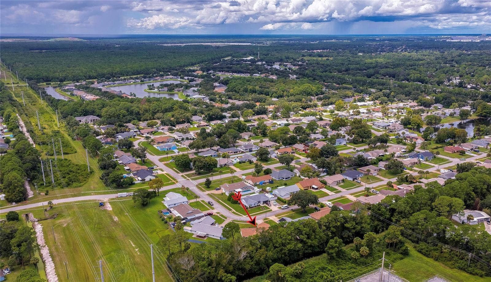 4669 SECRET RIVER TRAIL, Port Orange, FL 32129 Panoramic aerial perspective illustrating the quiet, wooded neighborhood layout and expansive green canopy.