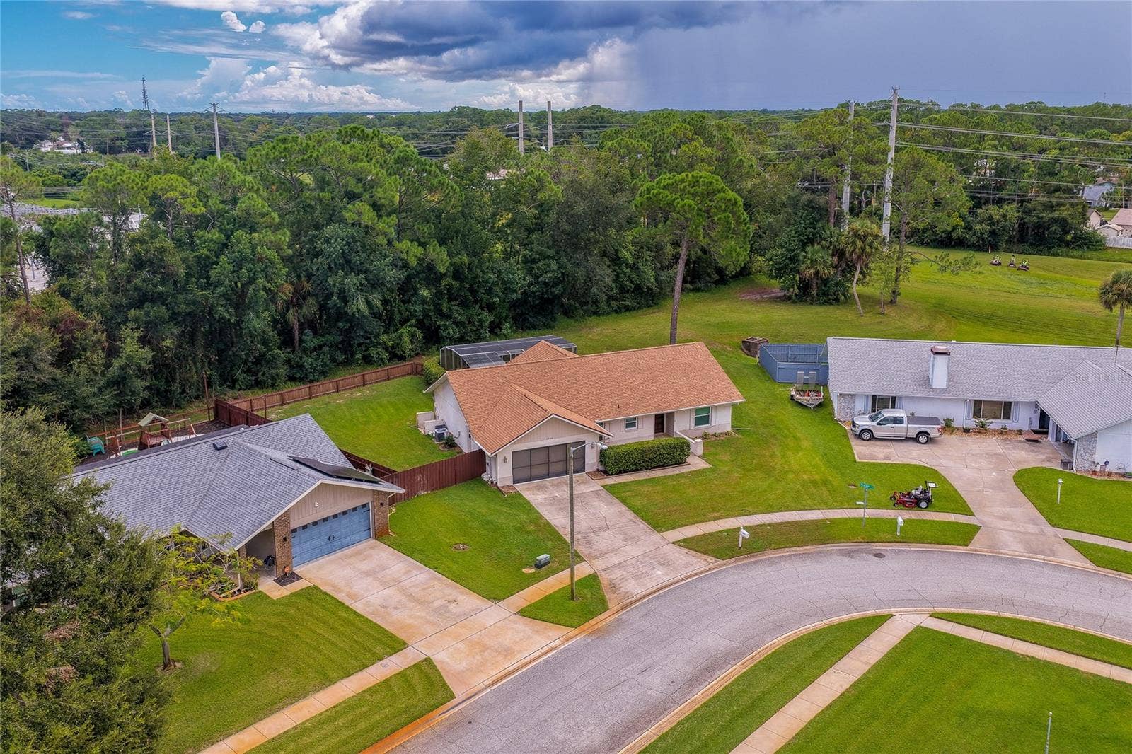 4669 SECRET RIVER TRAIL, Port Orange, FL 32129 Elevated neighborhood view displaying the property's location along a quiet residential street bordered by mature trees.