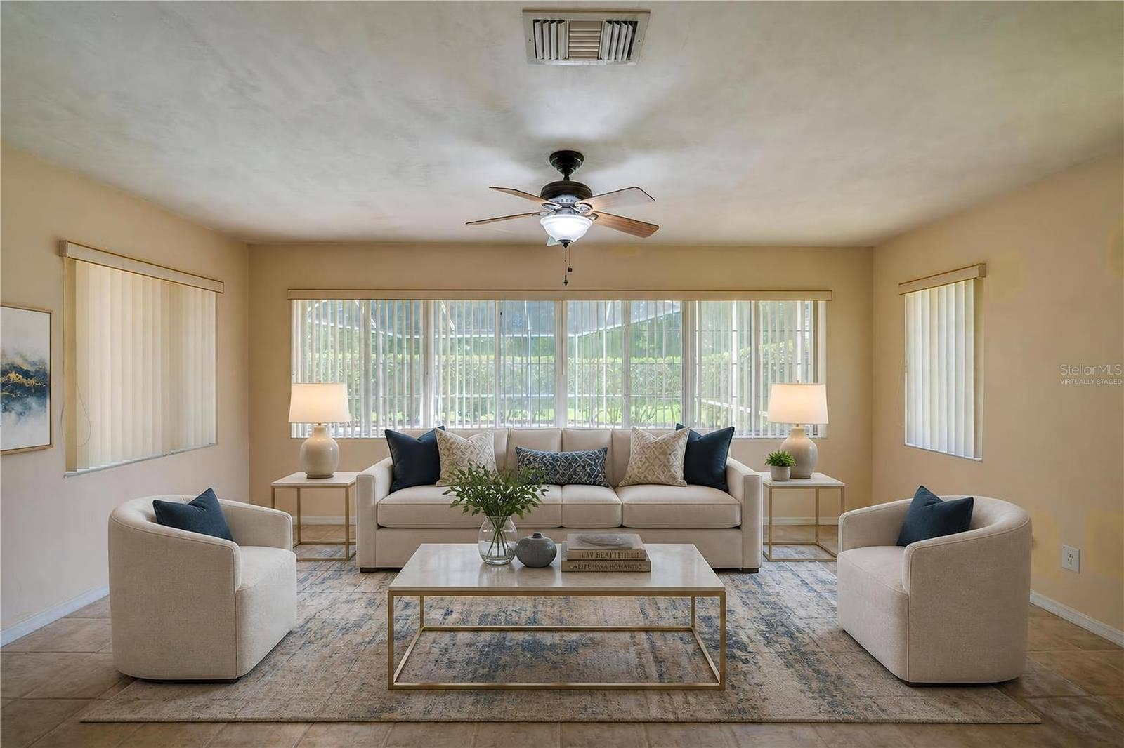 4669 SECRET RIVER TRAIL, Port Orange, FL 32129 Virtually Staged - Bright enclosed sunroom equipped with light beige tile flooring, a ceiling fan, and wide windows fitted with vertical blinds for controlled light.